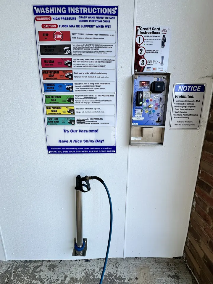Wash setting instructions, card and quarter payment equipment, and a spray wand at Inglewood Autowash.